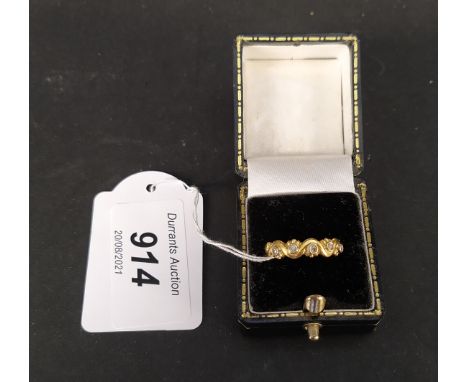 A continental yellow metal diamond set ring of wavy design, size O, weight approx 1.8g