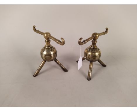 A pair of Arts and Crafts Christopher Dresser design globular brass fire dogs on tripod feet