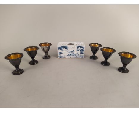 An Oxford Isis Ceramics flower brick, made by Deborah Sears in the Dutch style plus six plated egg cups
