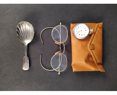 A Victorian silver caddy spoon, a continental lady's silver fob watch plus a pair of yellow metal framed glasses