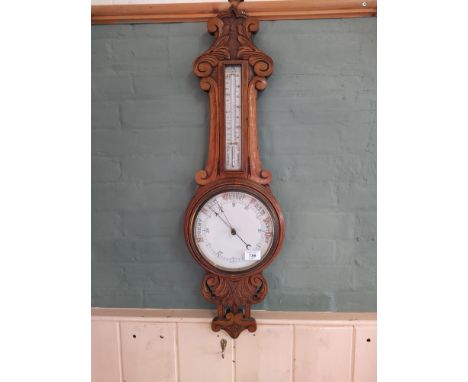 A carved oak framed banjo barometer, no makers mark, 34" long