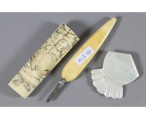 Two items of carved bone and a mother of pearl brooch.