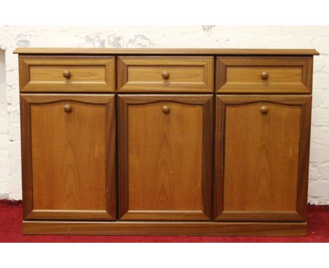 A light oak dresser of three drawers over cupboard base.