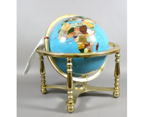 A large brassed based globe on gimble support set with semi-precious stones.