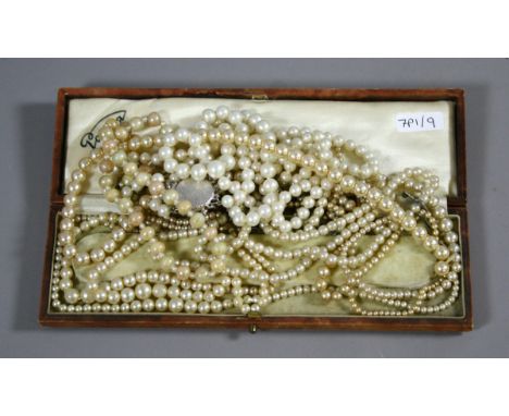 A case and contents of simulated pearl necklaces.