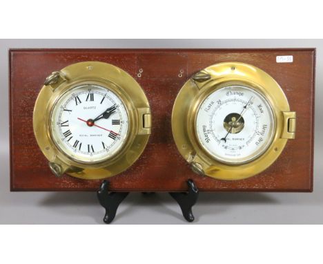 A brass cased Royal Mariner timepiece and matching barometer mounted on mahogany wall board.