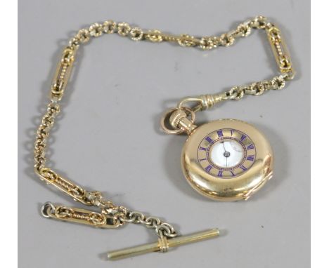 A small half hunter fob watch with enamel face and subsidiary dial by Thomas Russell & Son of Liverpool and a decorative yell