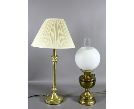 A brushed brass tablelamp along with an oil lamp effect tablelamp.