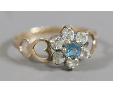 A ladies 9 carat gold blue topaz and cubic zirconia dress ring, 1.08 grams, UK size K.5.