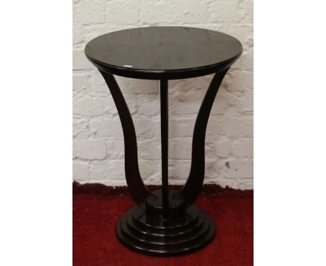 A mahogany circular lamp table raised on stepped base.