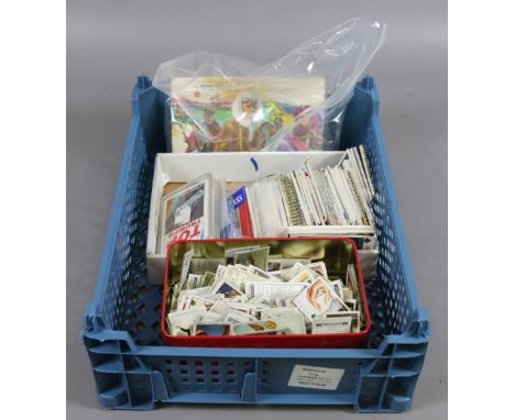 A box of cigarette cards along with a collection of sports related playing cards.