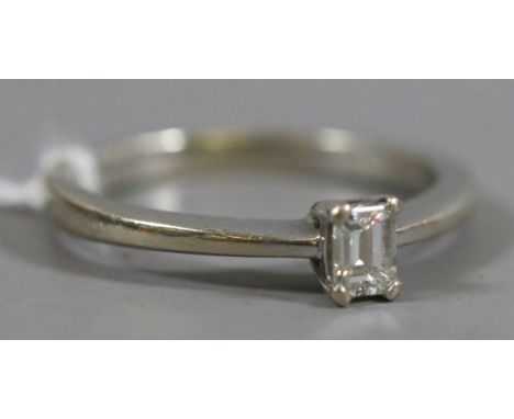 A ladies 18ct white gold and solitaire baguette cut diamond ring, 0.25ct diamond, 2.68 grams UK size K.