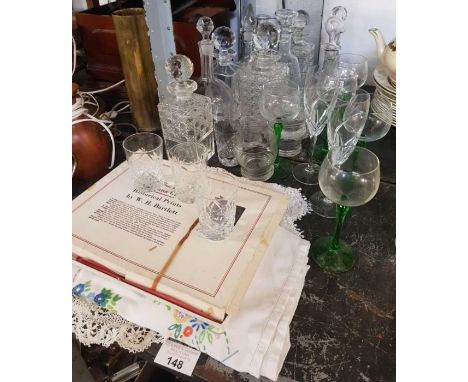 Various decanters, Alsace wine glasses, vintage lace, coloured lithograph prints