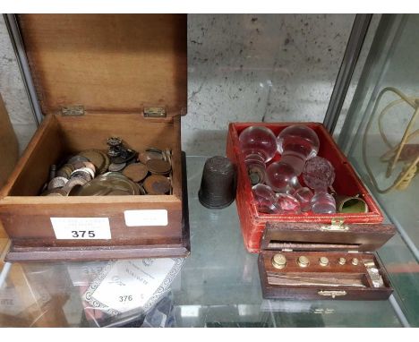 Shelf of items, coins, glass decanter bottle top, small boxed weighing scales for precious metals etc