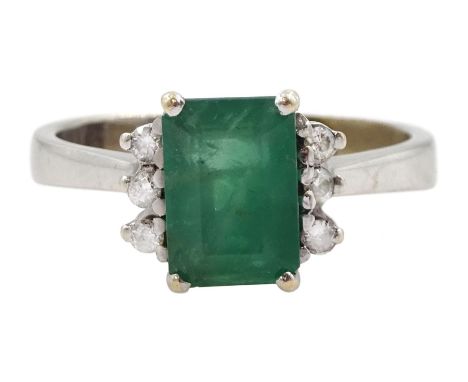 White gold emerald ring set with three round brilliant cut diamonds either sideCondition Report:Approx 4.7gm, tested 17ct, si