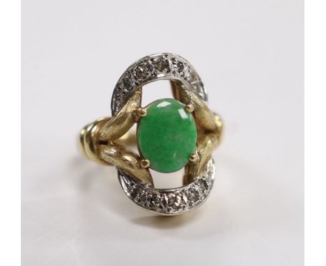 A 14k, oval cabochon jade and diamond cluster set dress ring, size J, gross weight 11.4 grams.