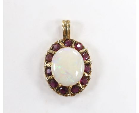 A modern 9ct gold, white opal and ruby set oval cluster pendant, overall 28mm, gross weight 3.6 grams.