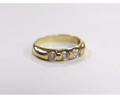 A yellow metal and three stone simulated diamond set ring, size K, gross weight, 2.7 grams.