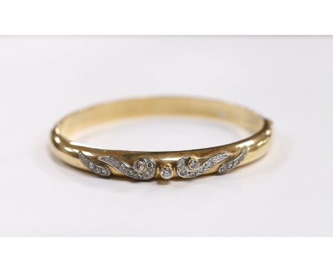 A 585 yellow metal and simulated diamond set hinged bangle, gross weight 20 grams.