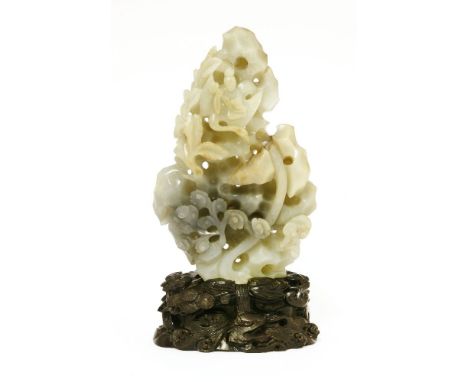 A Chinese jade carving,19th-20th century, of an immortal riding a crane flying amongst rocks with lingzhi, the stone of celad