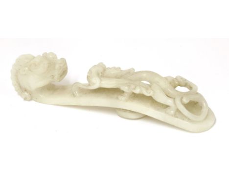 A Chinese jade belt hook,Qing dynasty (1644-1911), of typical form, one end with a dragon's head, the other with a chilong cl