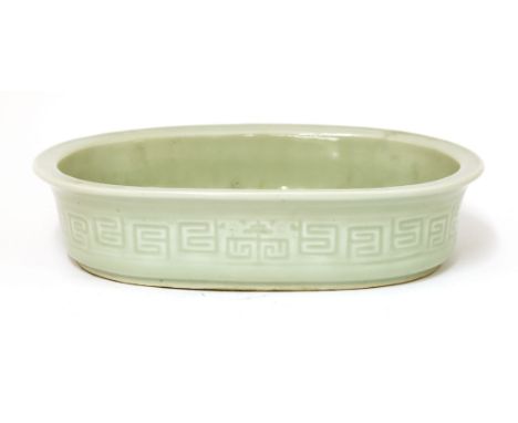 A Chinese porcelain narcissus planter,19th century, of oval form, decorated with archaic chilong and key frets to the sides, 