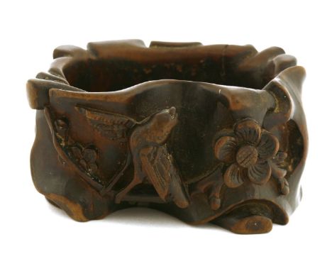 A Chinese boxwood brush washer,in the shape of a tree trunk, deeply carved with a magpie standing on a blossoming prunus bran