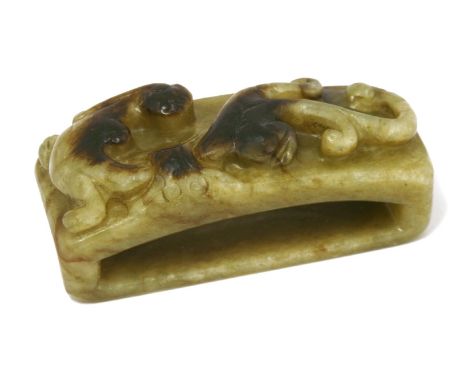 A Chinese jade belt buckle,Yuan dynasty (1279-1368), of rectangular form carved with a chilong, the celadon stone with coffee