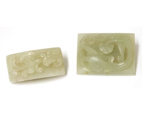 A Chinese jade belt hook, 20th century, of rectangular form, carved with a chilong in relief, 5.6cm long, and a sword section