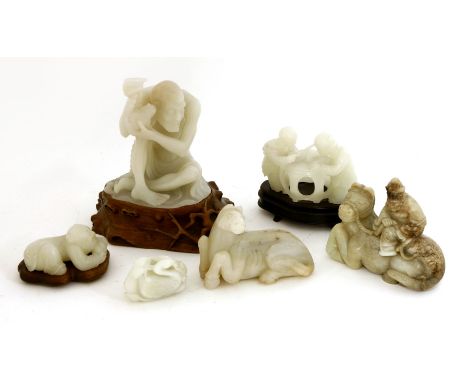 A collection of Chinese jade carvings, 20th century, comprising: a bearded man seated on the back of a recumbent horse, 13cm 
