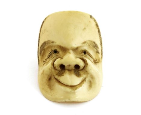 A Japanese ivory netsuke,Meiji period (1868-1912), of a theatrical mask of an old man,4.7cm long