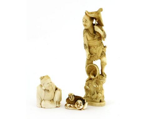 A collection of three Japanese ivory carvings, c.1900, one of a fisherman, 19cm high, a scholar, seated with his left hand re