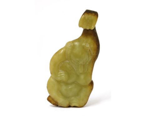 A Chinese jade belt hook, in the shape of a bear with a raised left arm forming the hook, the stone in a green tone with russ