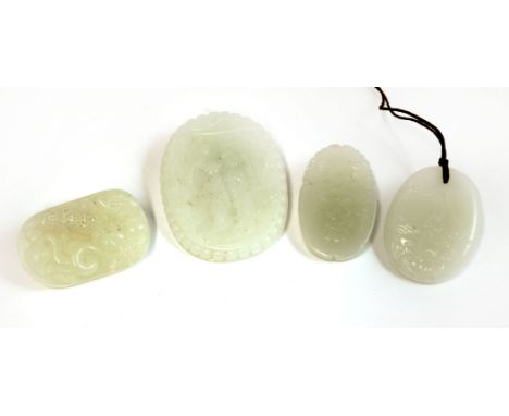 Four Chinese white jade plaques, 20th century, of oval form, one with a boy presenting a lingzhi in a shaped panel under two 