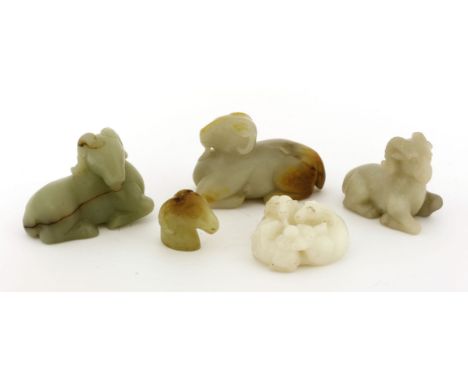 A collection of Chinese jade rams, 20th century, comprising three recumbent examples, a model of the head, and a group with t
