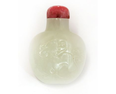 A Chinese jade snuff bottle,Qing dynasty (1644-1911), incised with a Buddhist lion to each side, the stone of white tone, tog