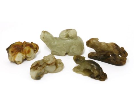 A collection of Chinese jades, 20th century, of mythical beasts, comprising a Buddhist lion and its pup playing a ball and tw