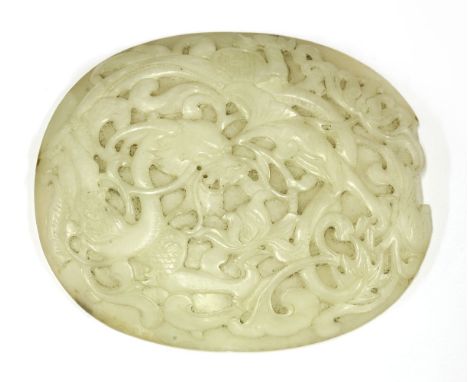 A Chinese jade carving,Qianlong (1736-1795), of oval form, carved in low relief with a dragon amongst scrolling peony, the st