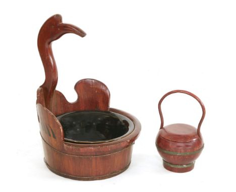 A Chinese wooden basin, in the form of a crane with its wings outstretched, enclosing an associated black-glazed bowl, 59.5cm