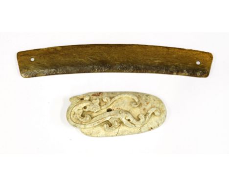 A Chinese jade pendant, huang,Shang dynasty (16th century BC - 1050 BC) or earlier, of arc shape, plain, each end with a dril