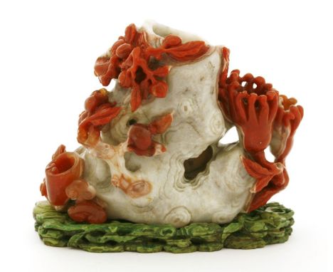 A Chinese agate vase,in the shape of a gnarled tree trunk surrounded by peaches, pomegranates, finger citron and lingzhi, 17c