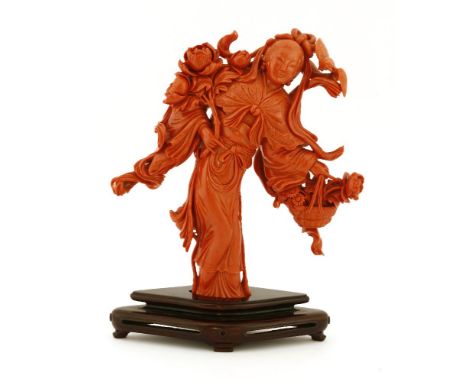 A Chinese coral figure,20th century, of a girl in elaborate robes with a scarf around her shoulders, standing with her waist 