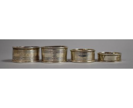 A Collection of Four Silver Napkin Rings, Two with Sheffield Hallmarks, One Birmingham and One Chester 1911 