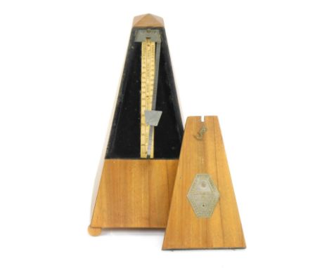 A metronome, stamped Maelzel, on bun feet, 22cm high.