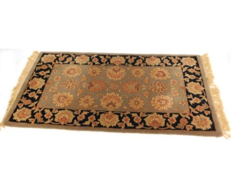 An Eastern rug, on a dark blue and light blue ground, with flowers, 156cm x 95cm.