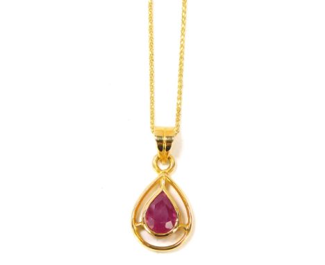 A ruby pendant and chain, the tear drop shaped pendant set with central faceted stone, on a fine link neck chain, yellow meta