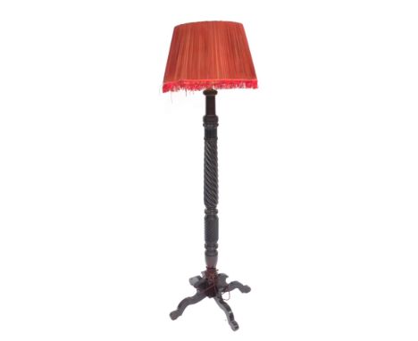 A mahogany standard lamp, with four splayed legs, on barley twist columns with later shade, 180cm high. WARNING! This lot con
