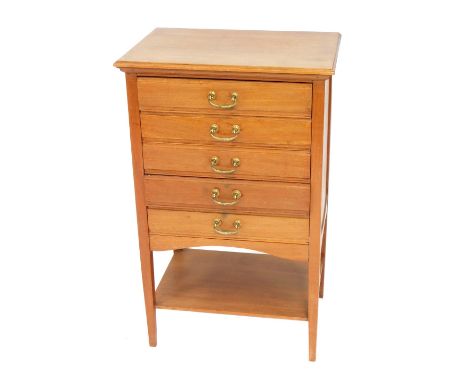 A light oak music cabinet, with five drawers, on tapered legs, 84cm high, 53cm wide, 37cm deep.