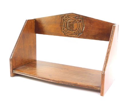 A 20thC oak book trough, with initialled rosette back and plain border base, 15cm high.