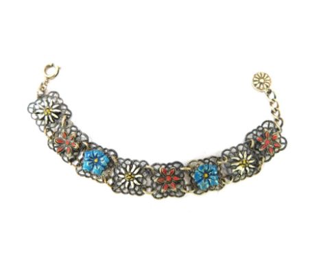 A continental enamel bracelet, with square set filigree type links, with blue, white and red enamel flowers to centre, white 